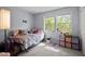 Sunny bedroom features two windows, a cozy bed, and playful decor at 115 Coleridge Ct, Carrboro, NC 27510