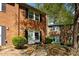 Classic brick townhome with neat landscaping, offering a timeless and welcoming curb appeal at 115 Coleridge Ct, Carrboro, NC 27510