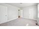 Spacious bedroom with neutral carpet, painted walls, and multiple doors at 115 Higbee St, Durham, NC 27704