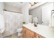 Bright bathroom featuring a spacious vanity with ample storage, a large mirror, and a shower with curtain at 1208 Steinbeck Dr, Durham, NC 27703