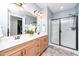 Bathroom featuring double sinks, modern fixtures, and a walk-in shower, combining style and functionality at 1208 Steinbeck Dr, Durham, NC 27703