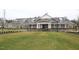 Stately clubhouse featuring a welcoming entrance, manicured lawn, and ample parking for community gatherings and events at 1208 Steinbeck Dr, Durham, NC 27703