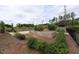 Community garden featuring raised beds and a seating area surrounded by lush greenery and a view of the court at 1208 Steinbeck Dr, Durham, NC 27703