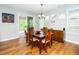 Bright dining room featuring hardwood floors and sliding glass doors to the outdoor patio at 1208 Steinbeck Dr, Durham, NC 27703