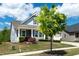 This charming home boasts a lovely front yard and a welcoming porch, perfect for enjoying the outdoors at 1208 Steinbeck Dr, Durham, NC 27703