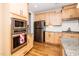 Gourmet kitchen featuring stainless appliances, granite counters and custom cabinetry at 1208 Steinbeck Dr, Durham, NC 27703