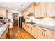 Bright and open kitchen featuring custom cabinetry, granite counters, and hardwood floors at 1208 Steinbeck Dr, Durham, NC 27703