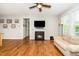 Living room with hardwood floors and a fireplace, creating a cozy and inviting atmosphere at 1208 Steinbeck Dr, Durham, NC 27703