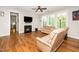 Cozy living room with fireplace, hardwood floors, ceiling fan and ample natural light at 1208 Steinbeck Dr, Durham, NC 27703