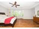 Spacious main bedroom with hardwood floors, crown molding and a large window overlooking the backyard at 1208 Steinbeck Dr, Durham, NC 27703