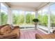 Inviting sunroom filled with natural light, offering views of the surrounding greenery at 1208 Steinbeck Dr, Durham, NC 27703