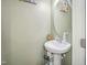 This bathroom features a pedestal sink, oval mirror, and decorative accents at 1304 Cozart St # 216, Durham, NC 27704