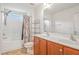 Bathroom with double vanity, bath tub, shower, and storage shelves at 1304 Cozart St # 216, Durham, NC 27704