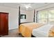 Bedroom featuring a four poster bed, ceiling fan, and a large window providing natural light at 1304 Cozart St # 216, Durham, NC 27704