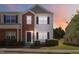 Attractive townhome featuring a brick and siding facade with well-maintained landscaping and sidewalk at 1304 Cozart St # 216, Durham, NC 27704