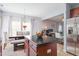 Kitchen island with dark countertops and hardwood floors, adjoining a dining area at 1304 Cozart St # 216, Durham, NC 27704
