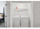 Convenient laundry room with washer, dryer, and storage shelf for optimal organization at 1304 Cozart St # 216, Durham, NC 27704