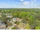 An aerial view showing the neighborhood homes and trees with the city skyline off in the distance at 1310 Mayfair Rd, Raleigh, NC 27608