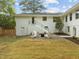 Large backyard with manicured lawn, a fire pit area, and access to the home's lower level at 1310 Mayfair Rd, Raleigh, NC 27608