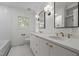 Beautiful bathroom featuring dual sinks, elegant lighting, and a soaking tub at 1310 Mayfair Rd, Raleigh, NC 27608