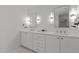 Elegant bathroom showcasing double vanity with white cabinets and modern fixtures at 1310 Mayfair Rd, Raleigh, NC 27608