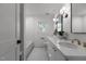 Bright bathroom with double sink vanity, updated fixtures, tile floors and shower at 1310 Mayfair Rd, Raleigh, NC 27608