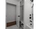 Well-lit bathroom features a walk-in shower and built-in shelving behind the door at 1310 Mayfair Rd, Raleigh, NC 27608