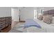 Cozy bedroom featuring hardwood floors, modern dresser, and patterned area rug at 1310 Mayfair Rd, Raleigh, NC 27608