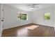 Sunlit bedroom featuring hardwood floors, two windows, and neutral paint at 1310 Mayfair Rd, Raleigh, NC 27608