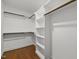 Spacious walk-in closet offering ample storage with built-in shelving and wooden rods at 1310 Mayfair Rd, Raleigh, NC 27608