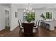 Elegant dining room features stylish chandelier, dark wood table, and bright natural light at 1310 Mayfair Rd, Raleigh, NC 27608