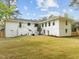 Expansive backyard with a fire pit area, well-maintained lawn, and a beautifully painted home exterior at 1310 Mayfair Rd, Raleigh, NC 27608