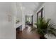 Stylish foyer with hardwood floors, white walls, modern lighting, and a view into the living space at 1310 Mayfair Rd, Raleigh, NC 27608