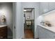 Hallway leading to a powder room and a kitchen area with white subway tiles and a coffee station at 1310 Mayfair Rd, Raleigh, NC 27608