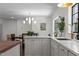 Bright kitchen featuring a large island, pendant lighting, and stainless steel sink at 1310 Mayfair Rd, Raleigh, NC 27608