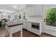 Modern kitchen with white cabinets, stainless steel appliances, and seamless flow to outside deck at 1310 Mayfair Rd, Raleigh, NC 27608