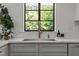 Close up of white marble counters, black window, with gold faucet in modern kitchen at 1310 Mayfair Rd, Raleigh, NC 27608