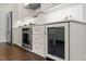 Gourmet kitchen features white cabinets, stainless steel appliances, and a built-in wine cooler at 1310 Mayfair Rd, Raleigh, NC 27608