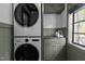 Well-organized laundry room with front loading washer and dryer with cabinetry at 1310 Mayfair Rd, Raleigh, NC 27608