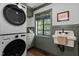 Laundry room featuring a stackable washer and dryer, with a large window at 1310 Mayfair Rd, Raleigh, NC 27608