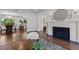 Bright living room featuring zebra rug, fireplace, and seamless flow to dining and bathroom at 1310 Mayfair Rd, Raleigh, NC 27608