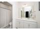 Well-lit bathroom featuring double sinks, patterned tile floor, and a shower at 1403 Chipping Dr, Apex, NC 27502