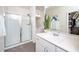 Clean bathroom featuring a glass enclosed shower and modern white cabinets at 1403 Chipping Dr, Apex, NC 27502