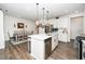 Spacious kitchen with large island and breakfast bar open to dining area at 1403 Chipping Dr, Apex, NC 27502