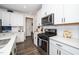 Close up of modern kitchen with stainless appliances and quartz countertops at 1403 Chipping Dr, Apex, NC 27502