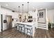 Modern kitchen with white cabinets, stainless steel appliances, and island seating at 1403 Chipping Dr, Apex, NC 27502