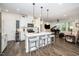 Modern kitchen with white cabinets, a center island with seating, and stainless steel appliances at 1403 Chipping Dr, Apex, NC 27502