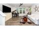 Living room featuring hardwood floors, entertainment center, and lots of light at 1403 Chipping Dr, Apex, NC 27502