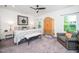 Comfortable main bedroom boasts a decorative accent wall and a cozy sitting area at 1403 Chipping Dr, Apex, NC 27502