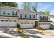 Modern townhouse with attached garage, neutral exterior, and well-maintained landscaping for curb appeal at 1403 Chipping Dr, Apex, NC 27502